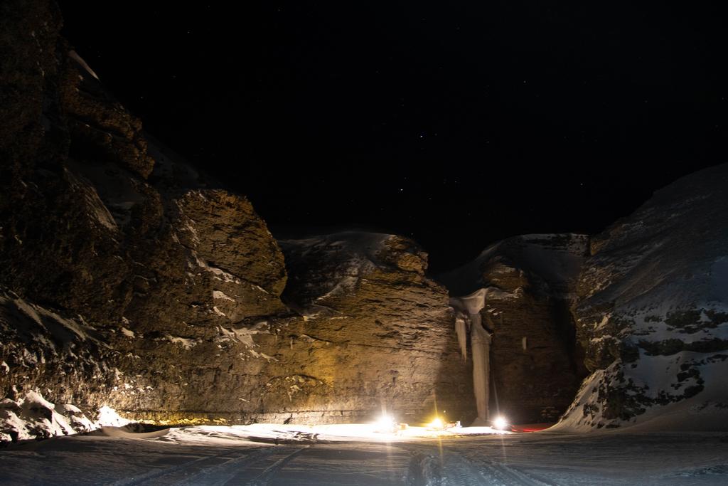 Snowmobile ride in a canyon on Svalbard