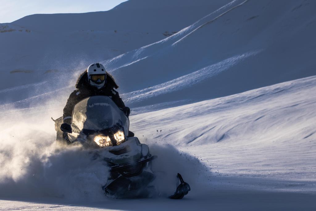 Fun in powder snow with snowmobile