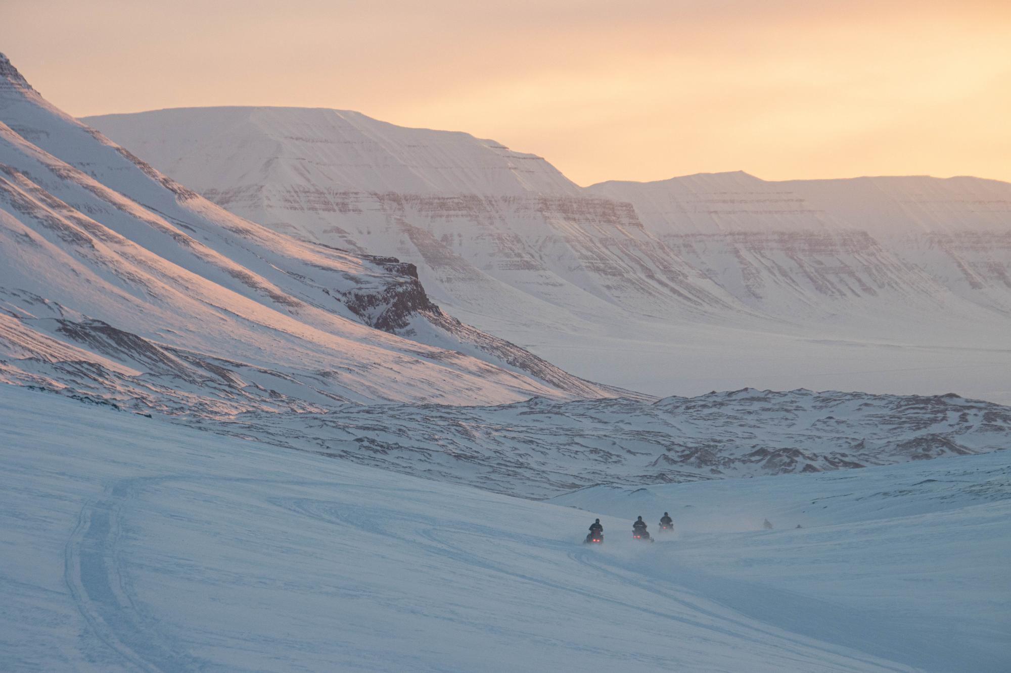 Driving snowscooter in the evening on Svalbard
